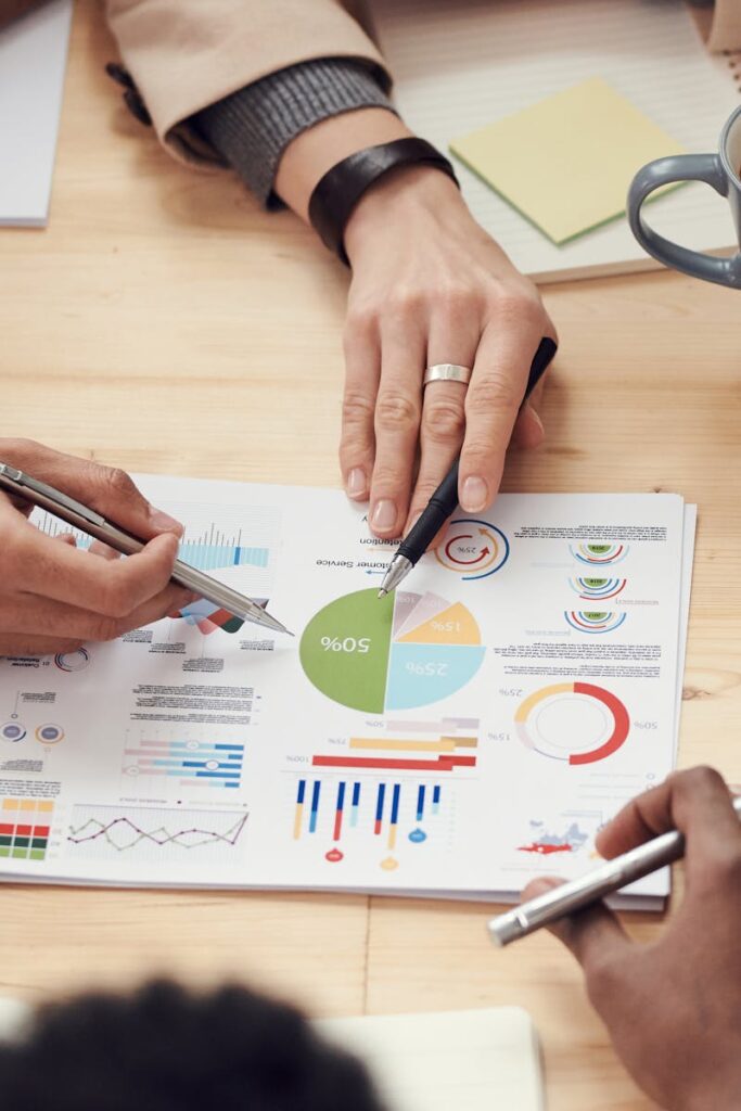 Colleagues discussing data and strategy in an office meeting.